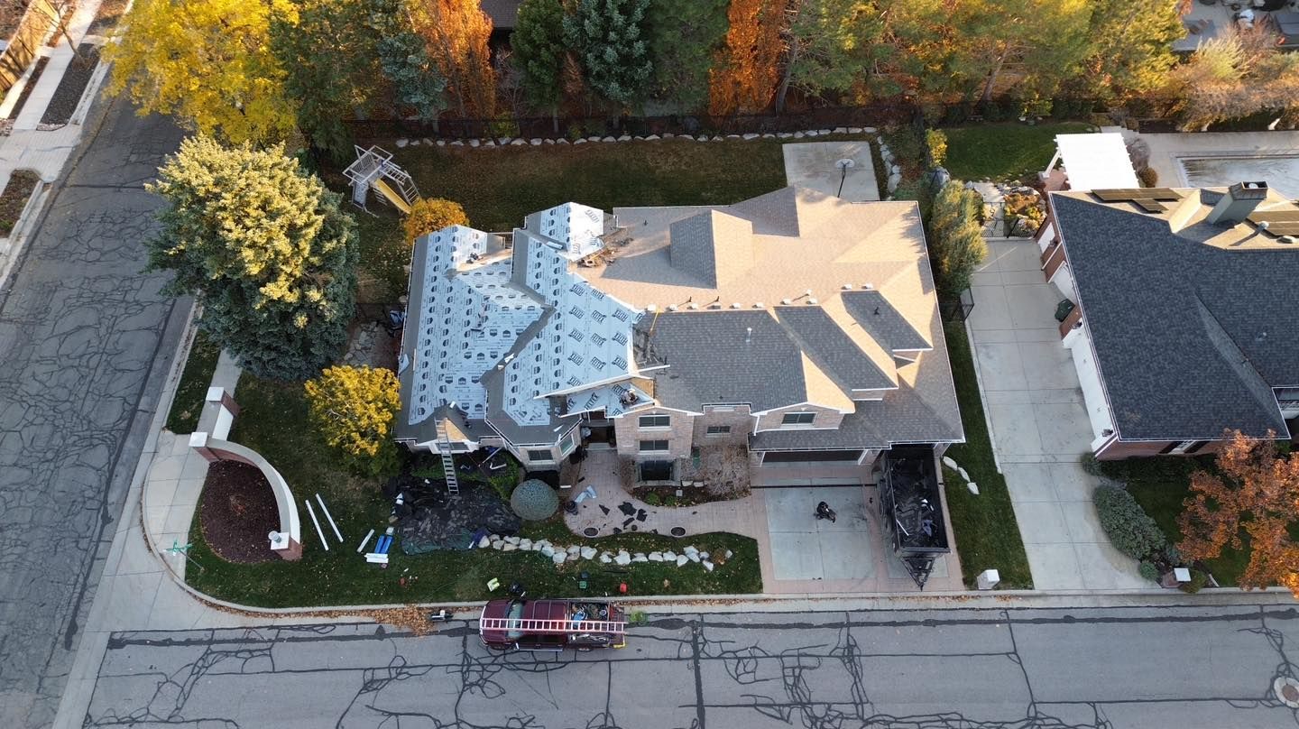 An aerial view of a house with a roof being installed.