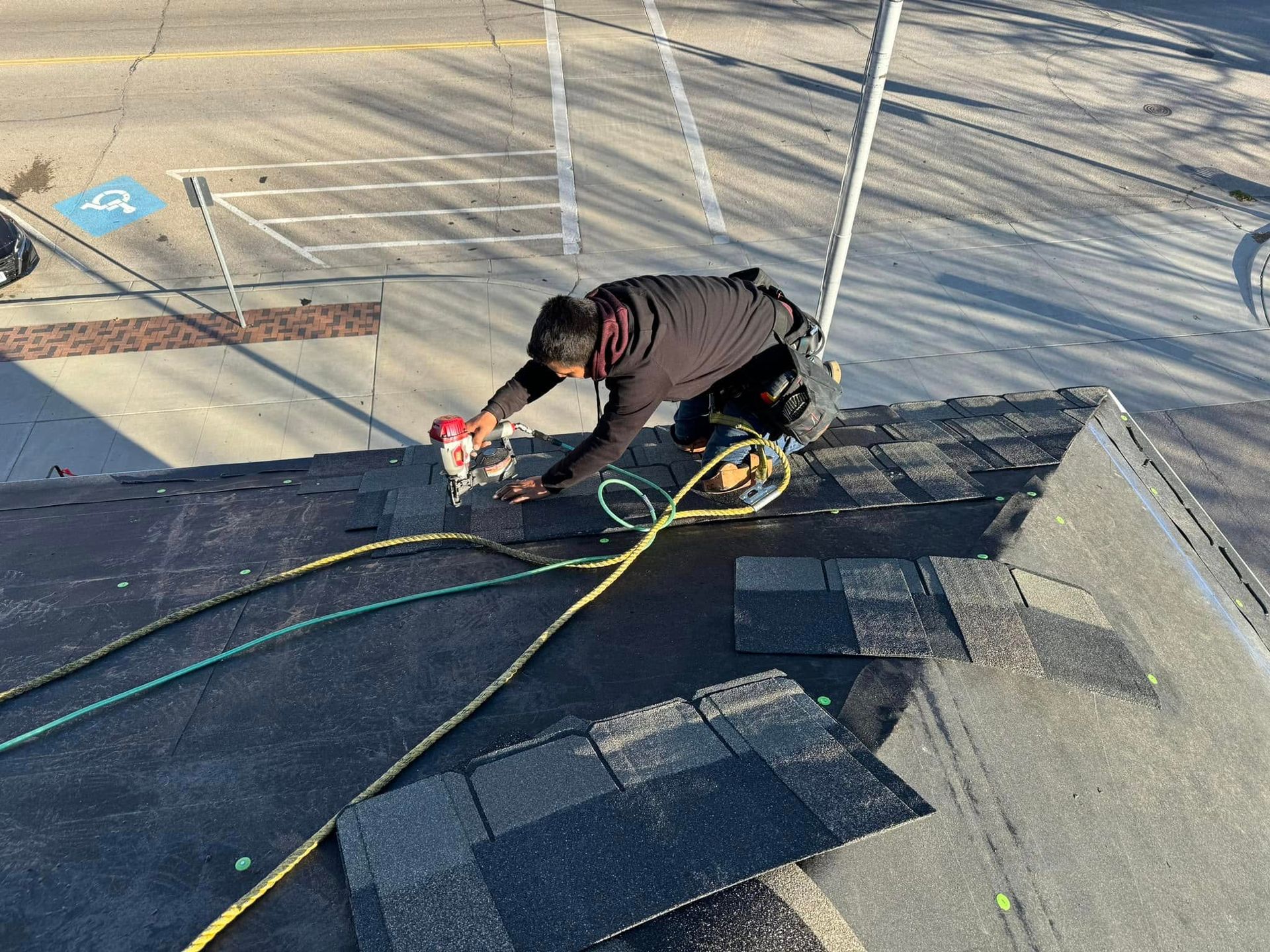 A man is working on the roof of a building.