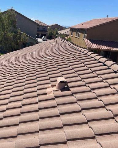 A roof with a chimney on it and a lot of tiles on it.