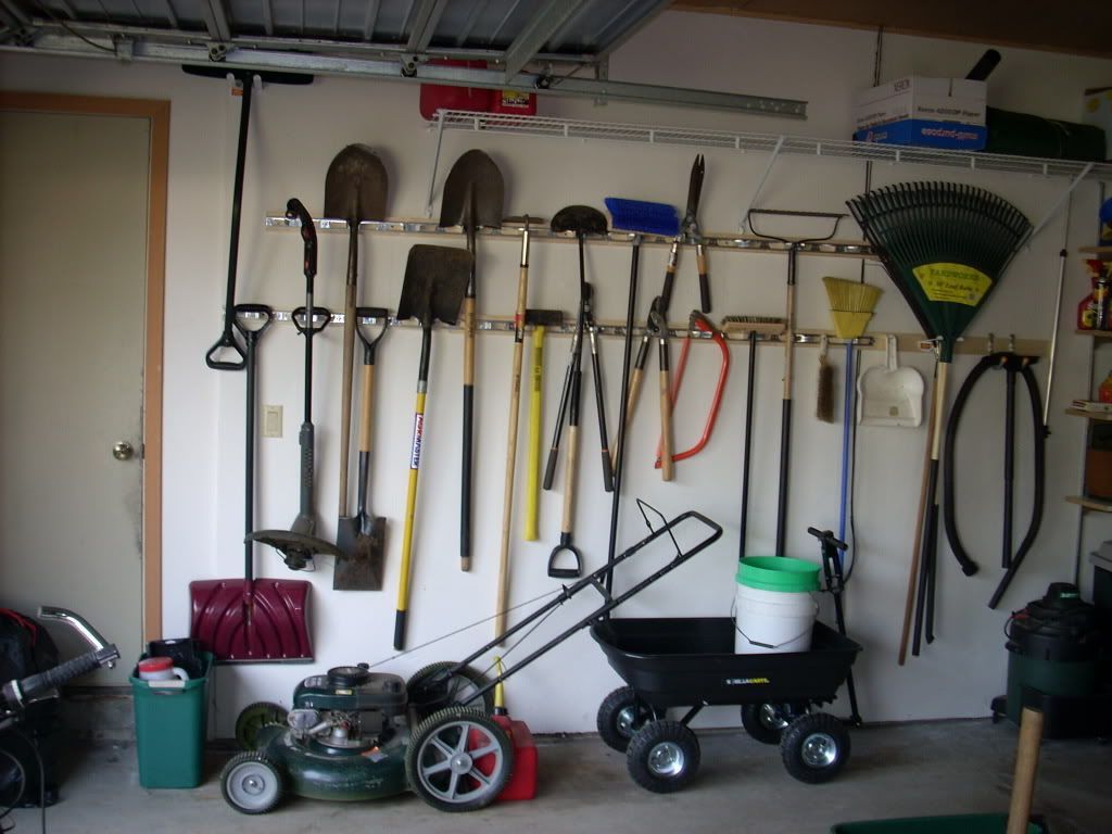A Bunch of Gardening Tools Hanging on a Wall in a Garage — Portsmouth, NH — Lager Susan R