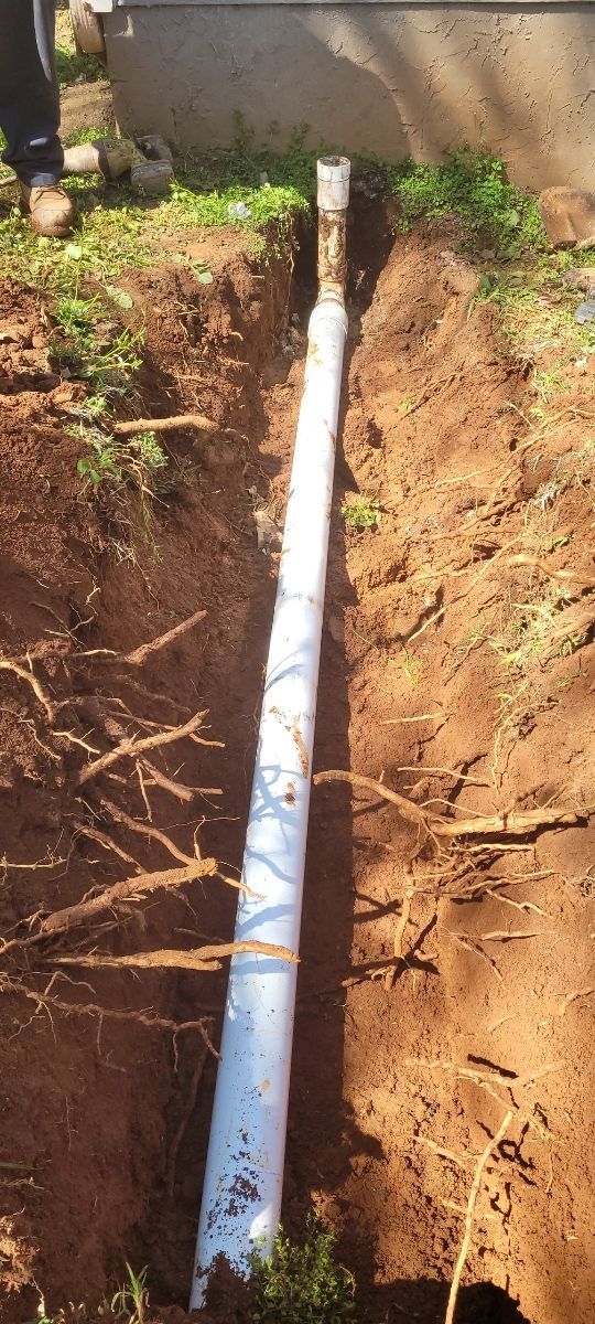White Pipe In Trench With Grass
