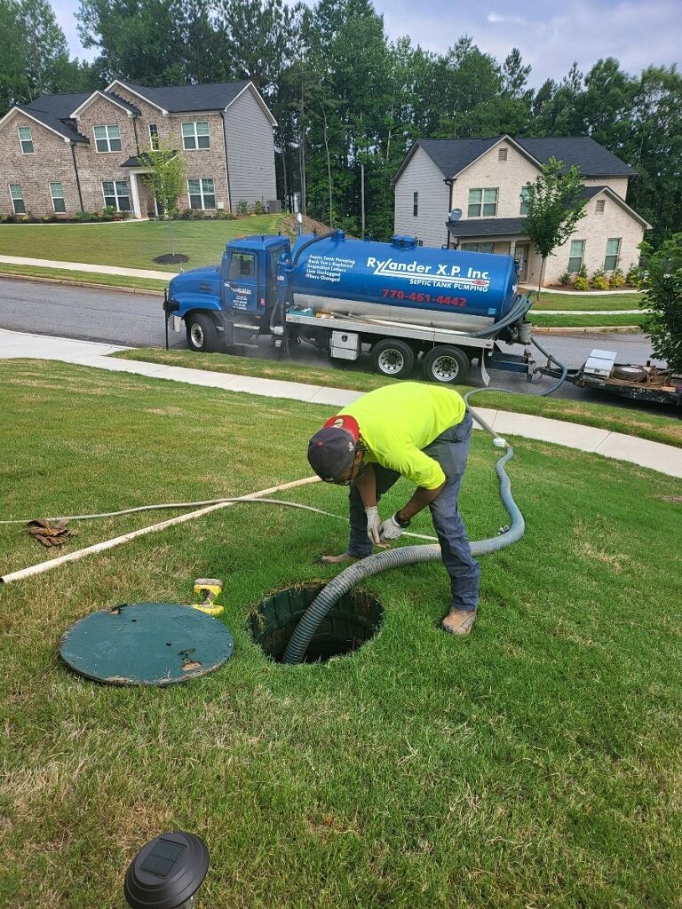 Man Pumping Septic Tank With Blue Truck