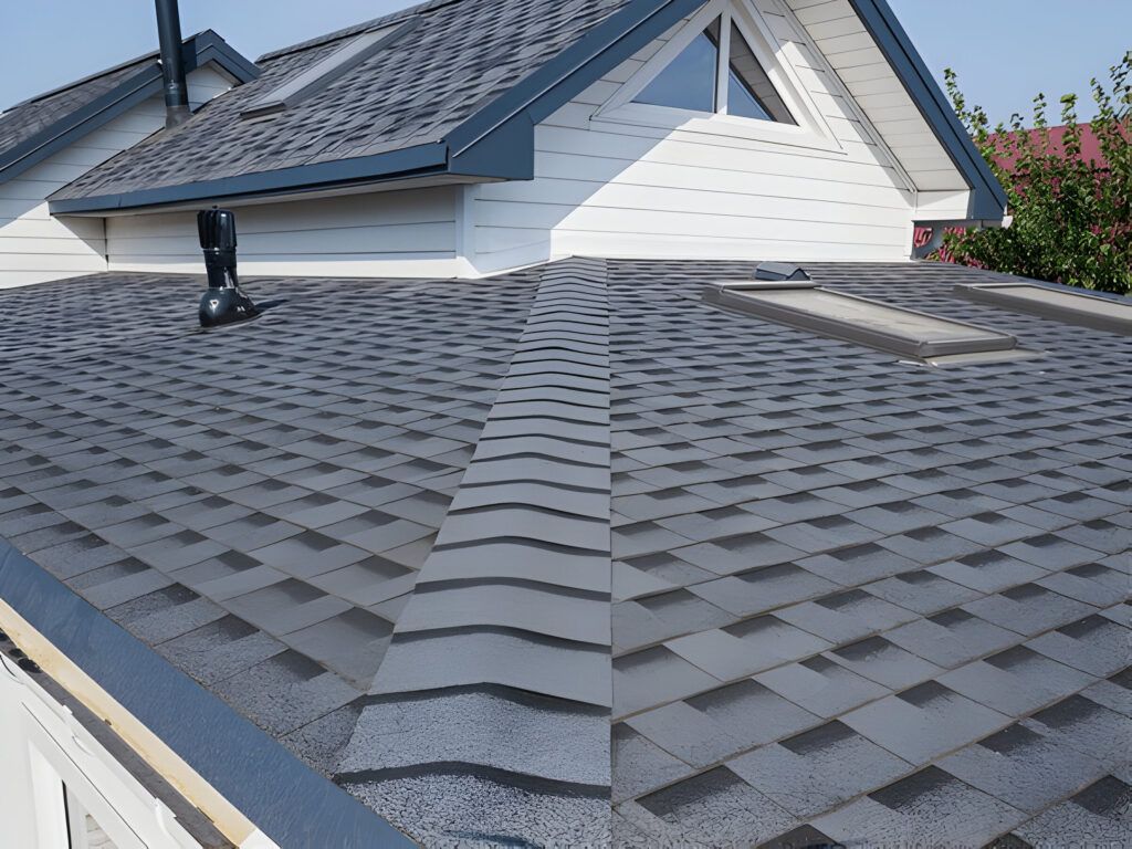 The roof of a house with a gray shingle roof