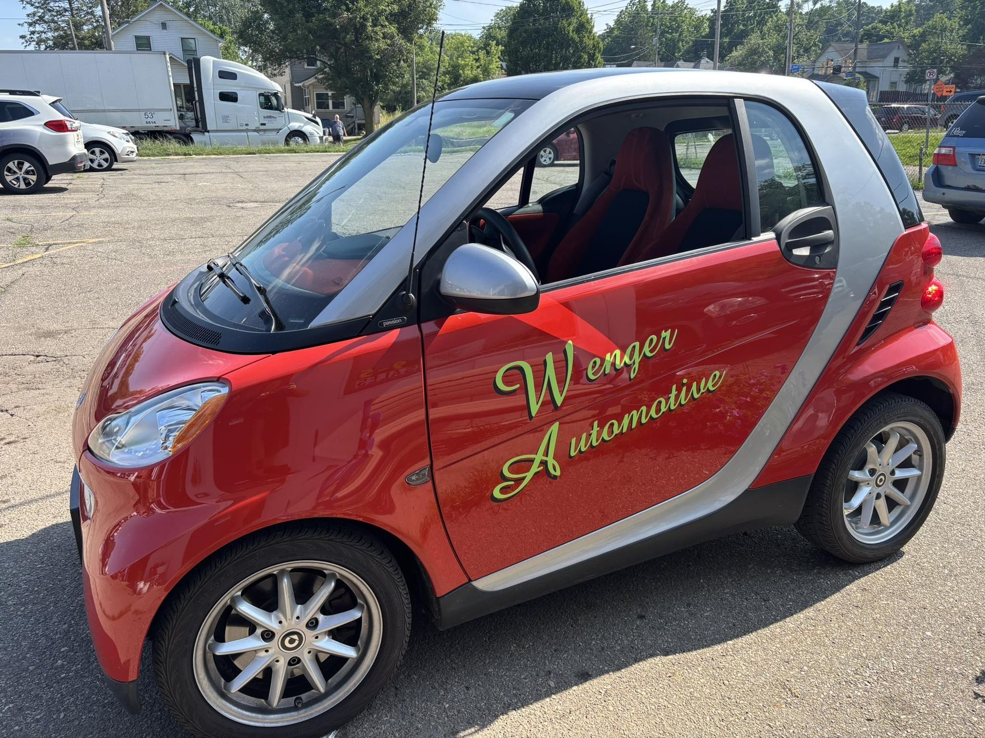 Red and silver Smart car with