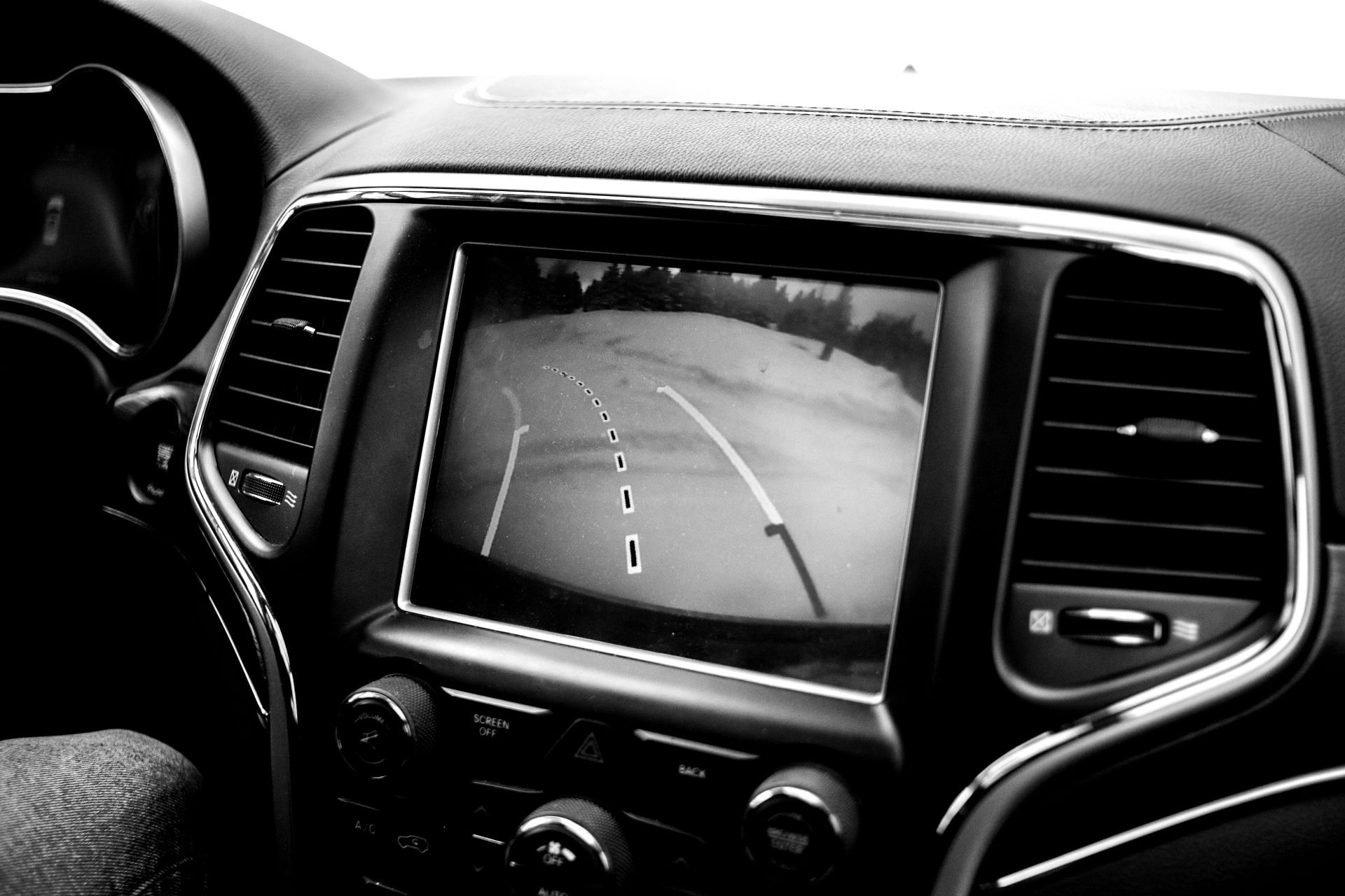A black and white photo of a car 's rear view camera.