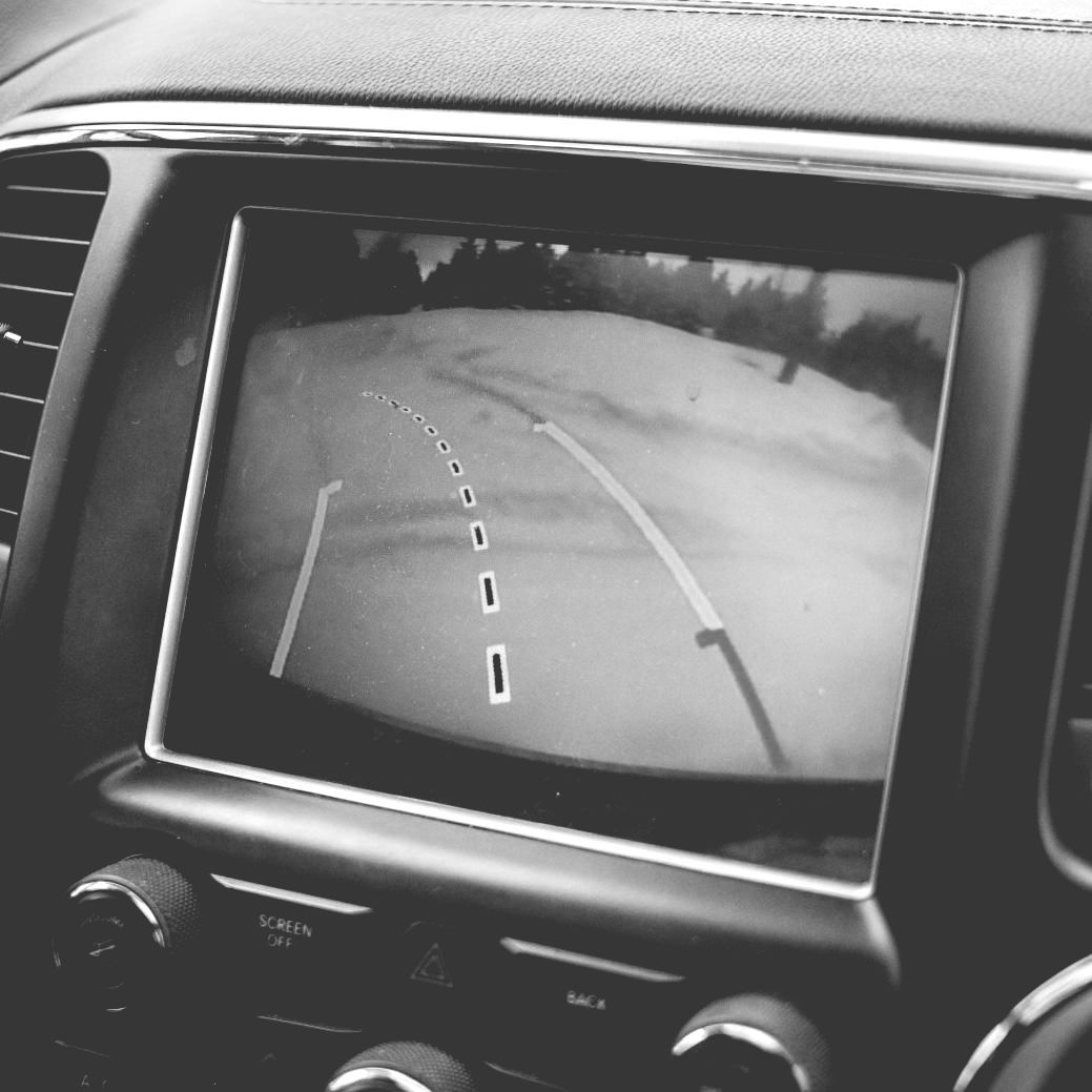 A black and white photo of a rear view camera in a car