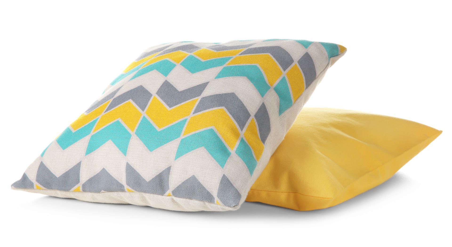 two colorful pillows are stacked on top of each other on a white background .