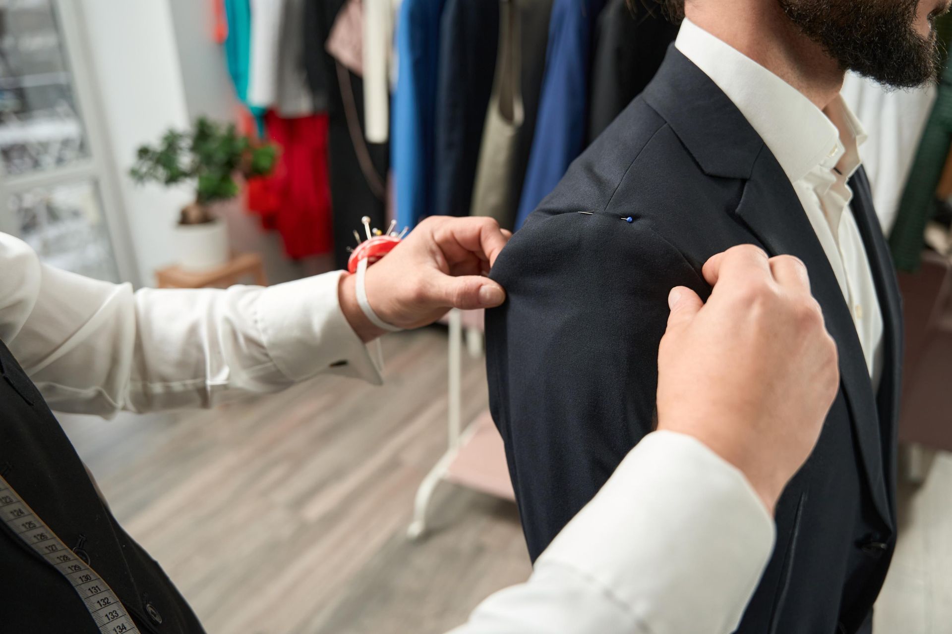 a man is getting his suit tailored by a tailor