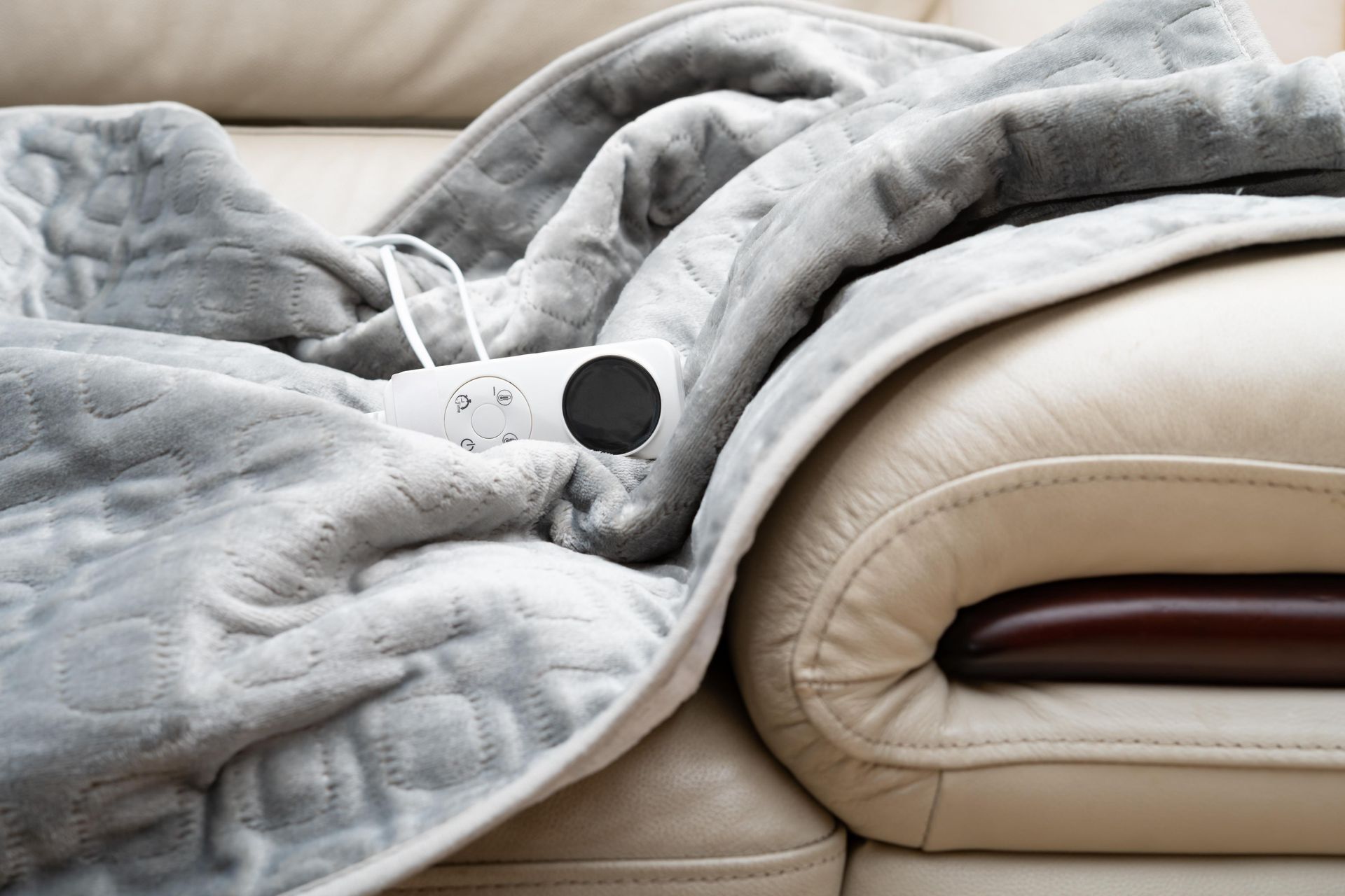 an electric blanket is sitting on top of a couch .
