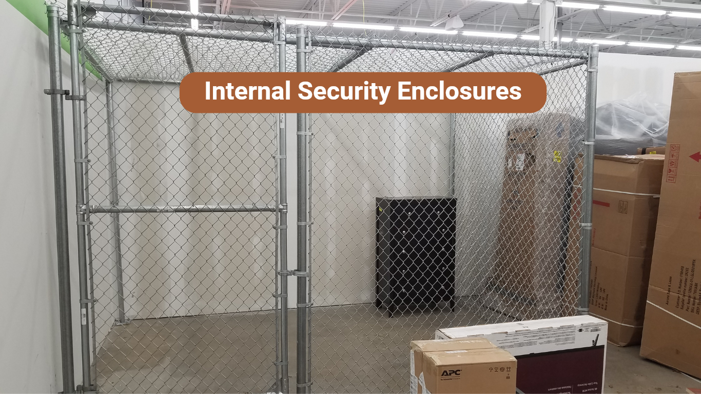 A metal chain link cage with a door inside a store. Boxes and a black container sit within the cage.