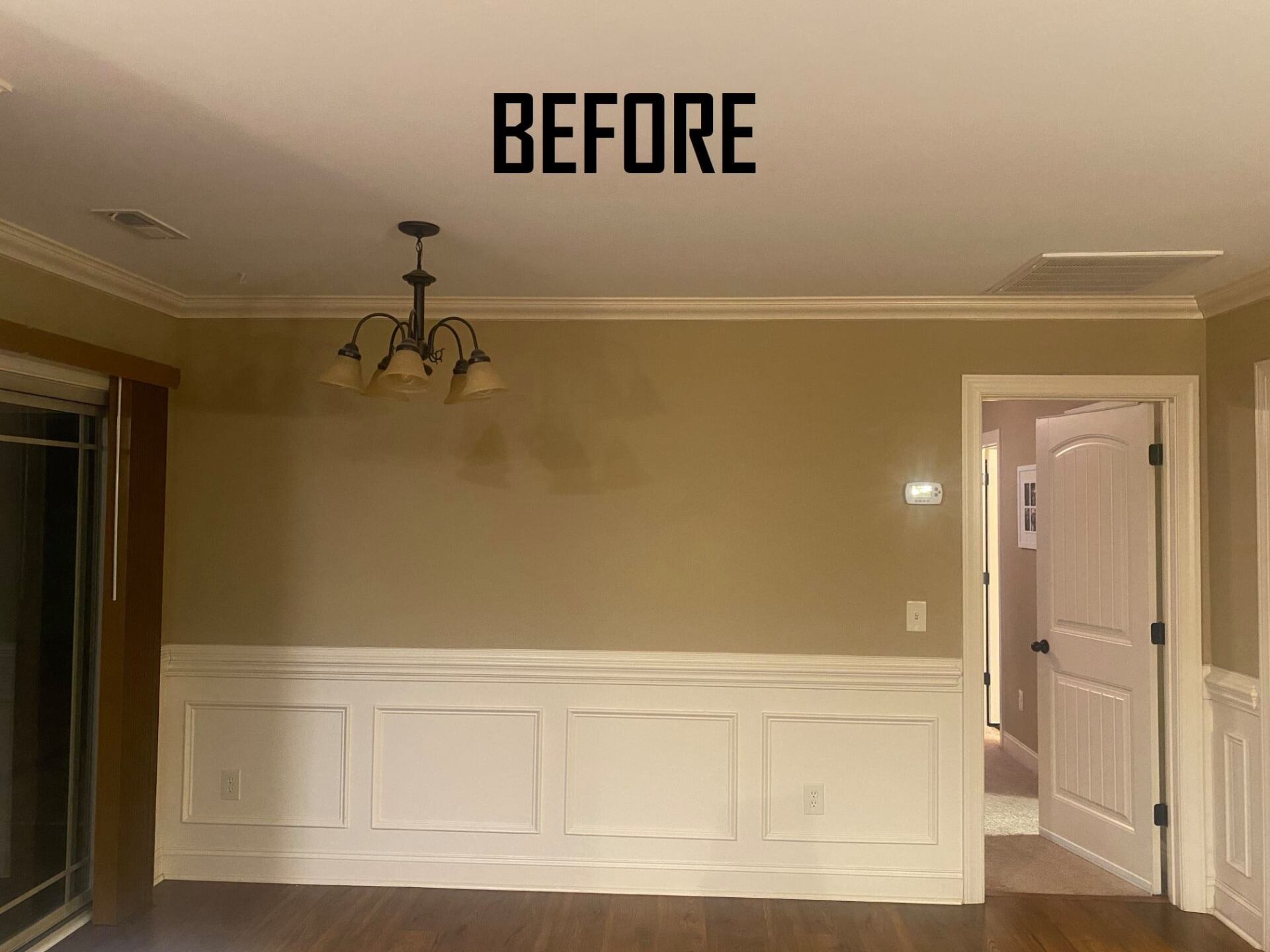 Dining room before renovation, featuring tan walls, white molding, and a chandelier.