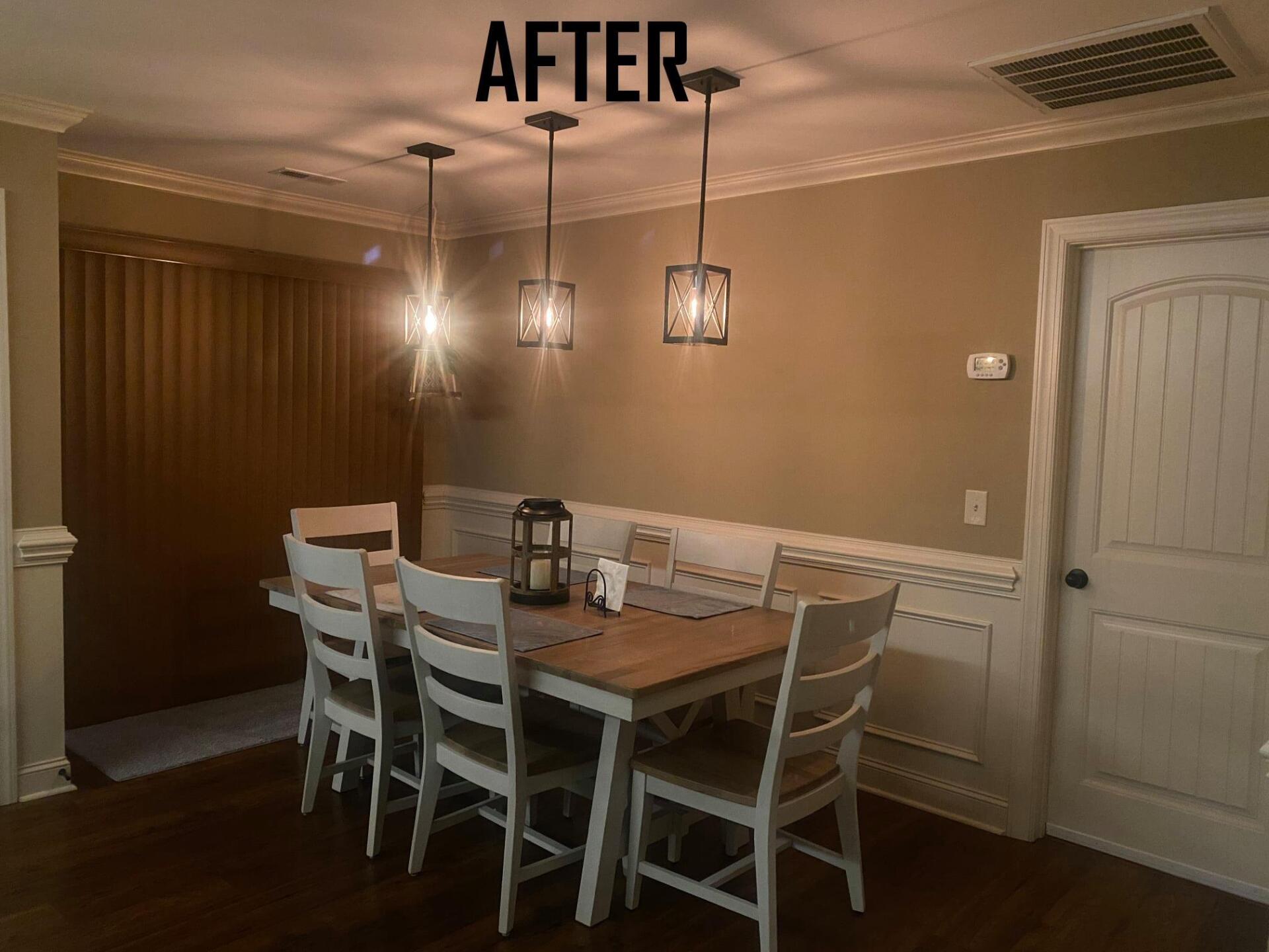 Dining room with wood table, six chairs, pendant lights, and decorative wall paneling.