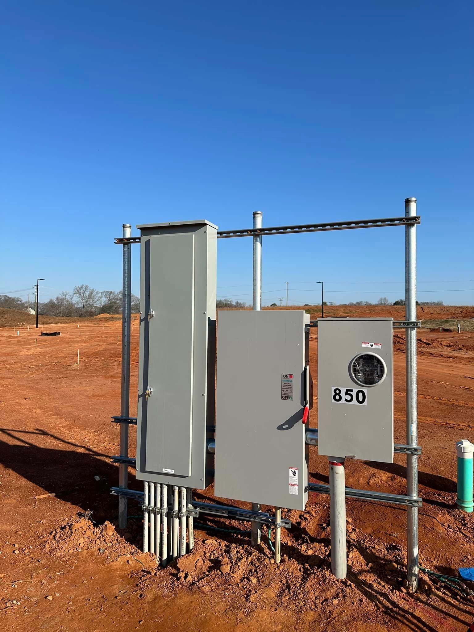 Electrical power boxes on a construction site with a blue sky.