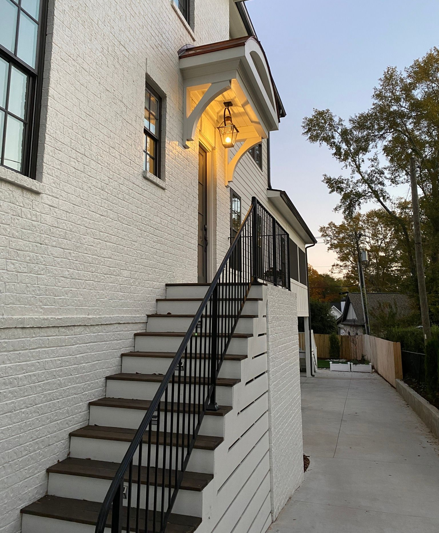 White brick home with new exterior lighting installed