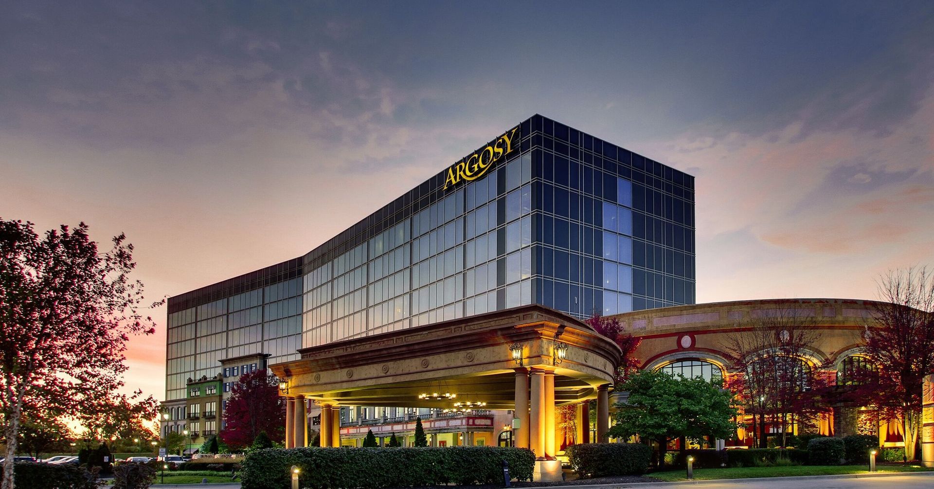 A large building with a lot of windows is lit up at night.