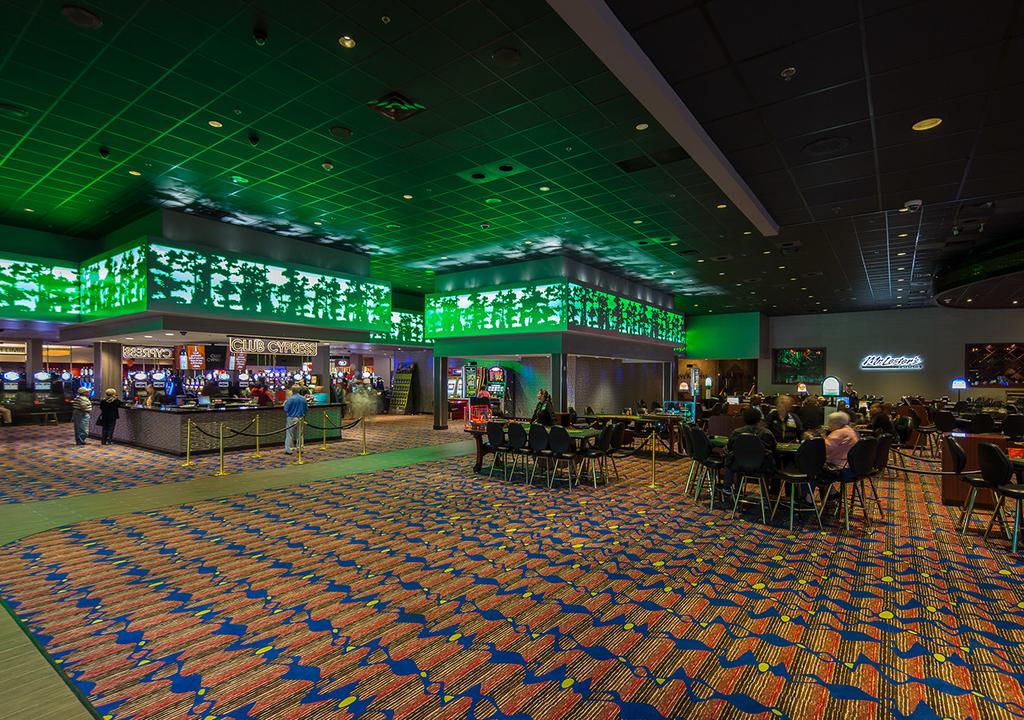 A large room with tables and chairs in a casino.
