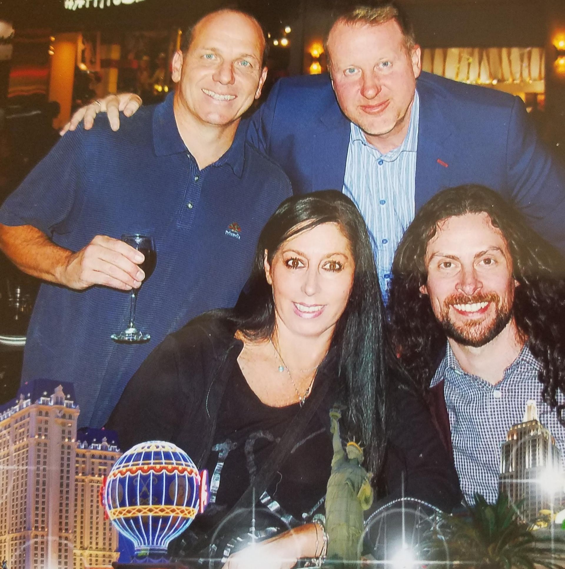 A group of people posing for a picture in front of a model of the world trade center