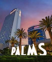 The palms hotel in las vegas is surrounded by palm trees and a tall building.