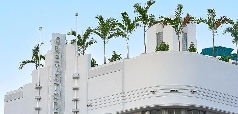 A large building with a lot of windows is lit up at night.