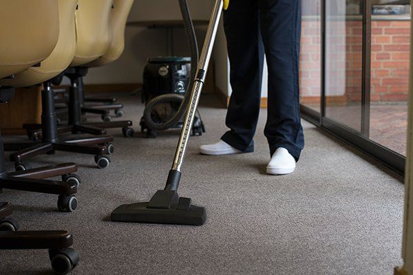 Man Vacuuming the Carpet of an Office — Fort Collins, CO — Aspen Enterprises of North Colorado