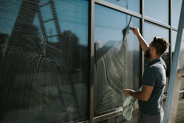 Man Cleaning the Window — Fort Collins, CO — Aspen Enterprises of North Colorado