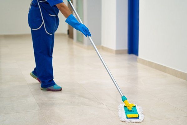 Cleaning Lady Cleans the Hallway with a Mop — Fort Collins, CO — Aspen Enterprises of North Colorado