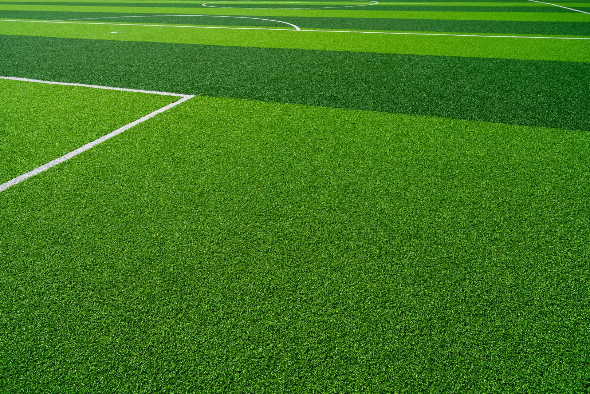 A roll of sod is sitting on the ground next to a lawn.