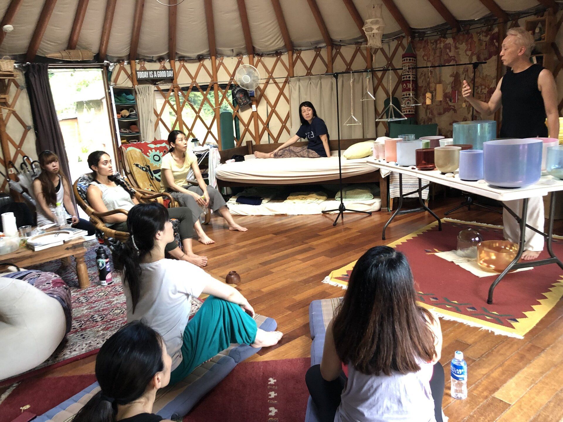 A group of people are sitting in a circle in a room.