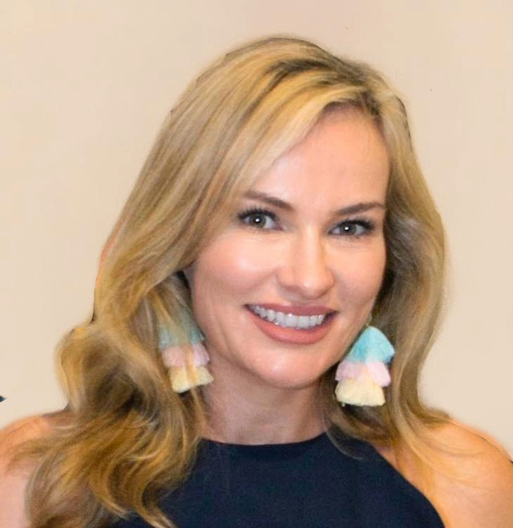 A woman wearing a black top and earrings smiles for the camera