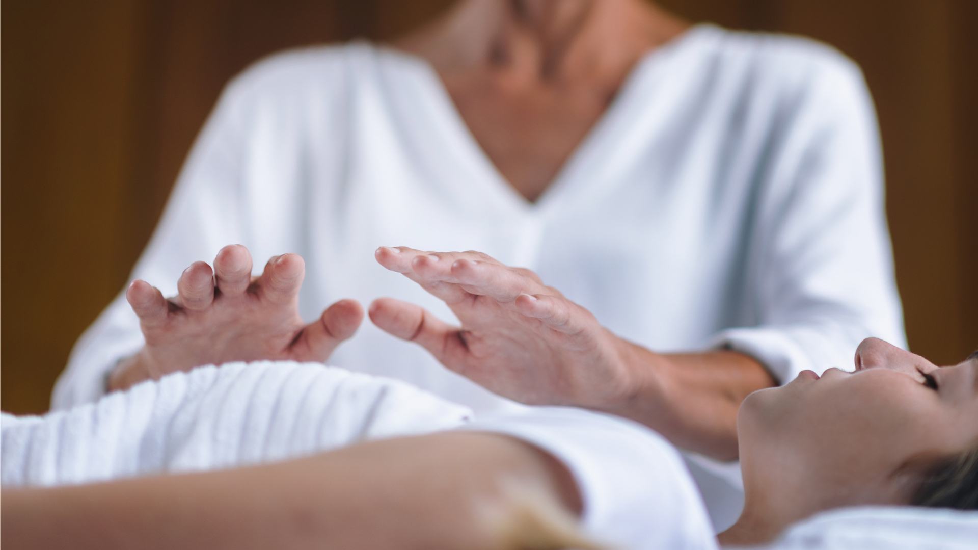 A woman is giving a healing session to another woman.