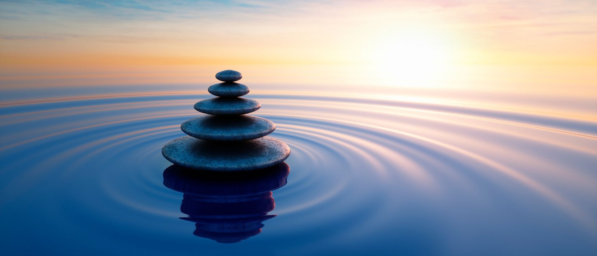 A stack of rocks floating on top of a body of water.