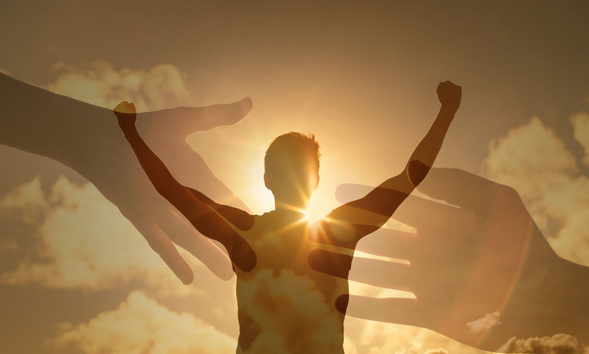 A silhouette of a man with his arms in the air surrounded by hands.