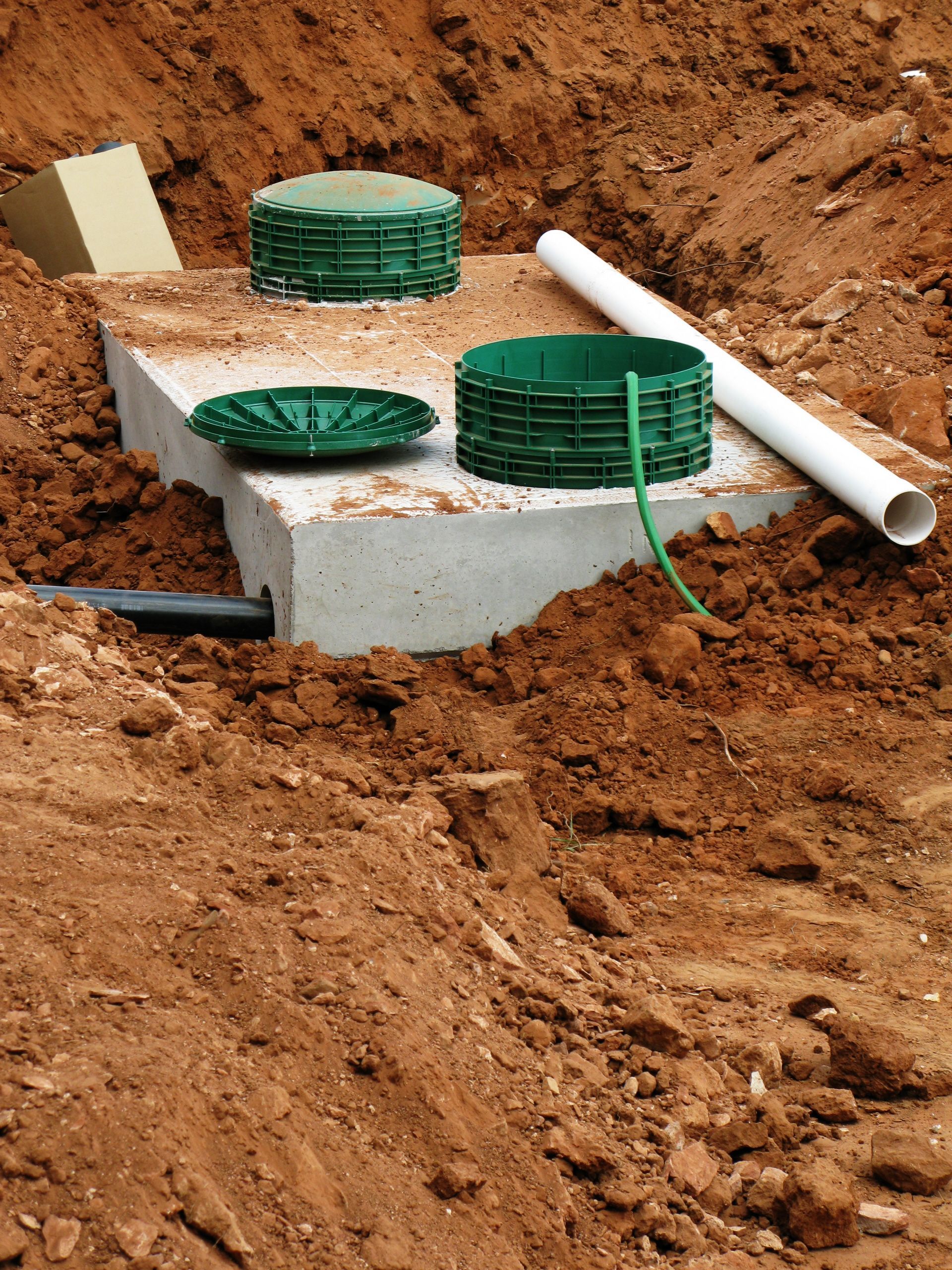 Septic system installation process showing water test in newly installed septic tank.