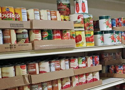 A can of diced tomatoes sits on a shelf in a store