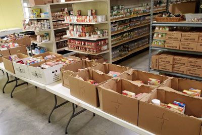 A room filled with lots of cardboard boxes filled with food.