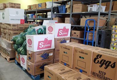 A warehouse filled with lots of boxes and watermelons.