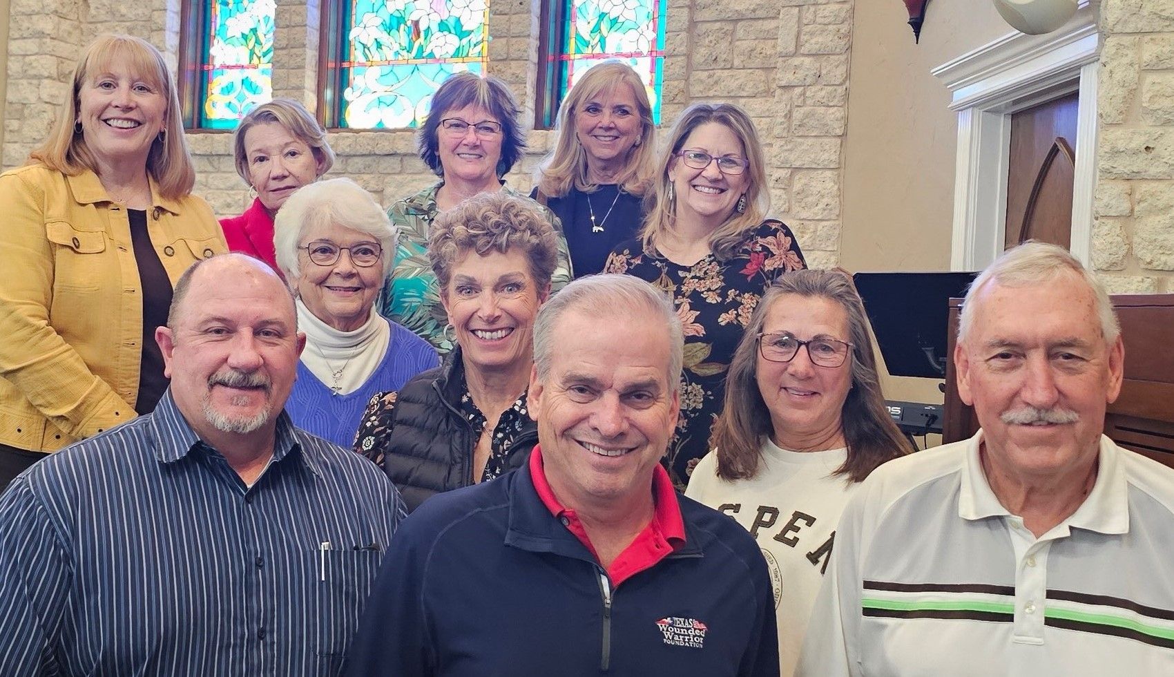 A group of people are posing for a picture in a church.