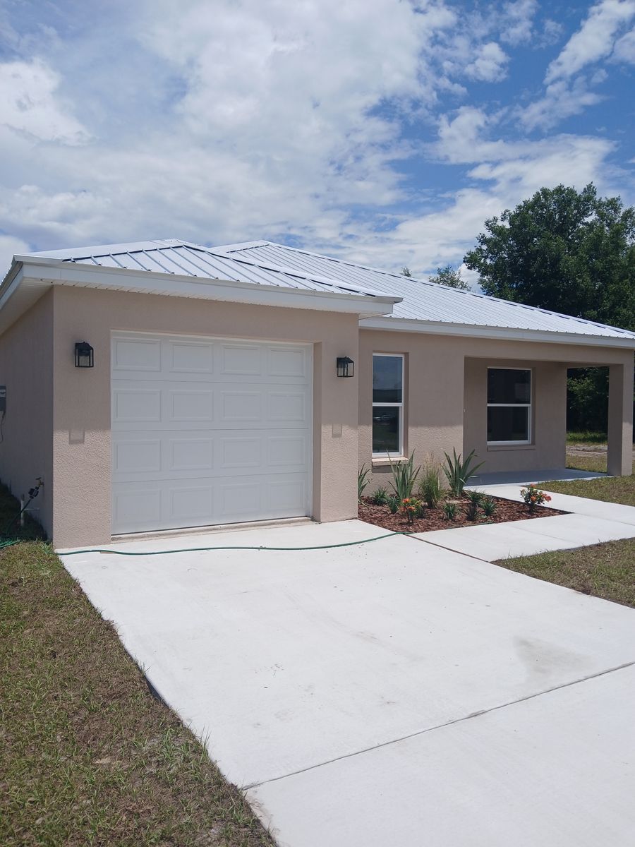 A house with a white garage door and a concrete driveway