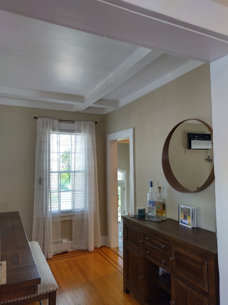 A dining room with a table and a mirror
