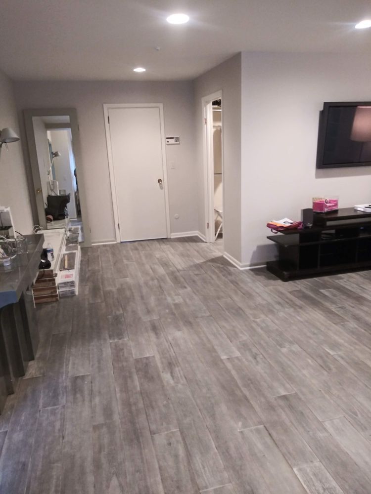 A living room with hardwood floors and a flat screen tv
