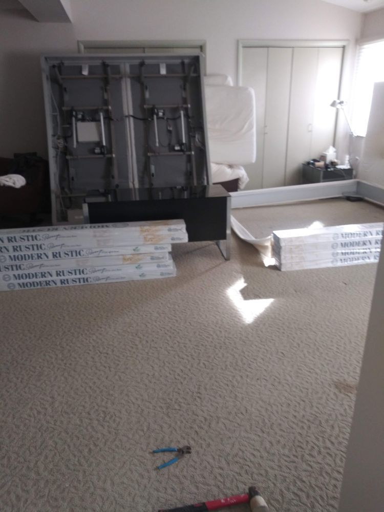 A room with a lot of boxes on the floor and a hammer on the floor