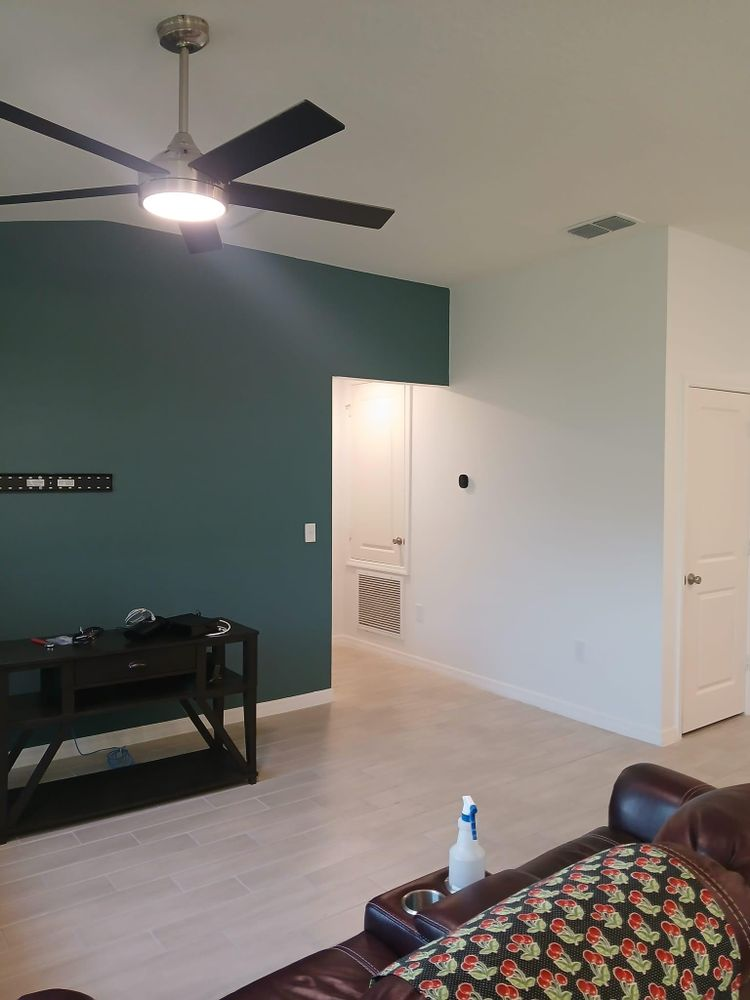 A living room with a ceiling fan and a couch