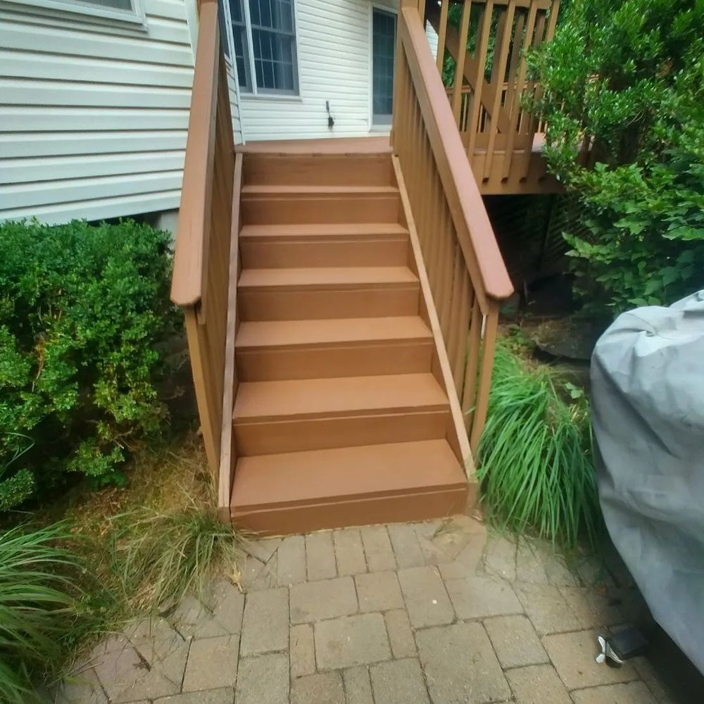 A set of wooden stairs leading up to a deck