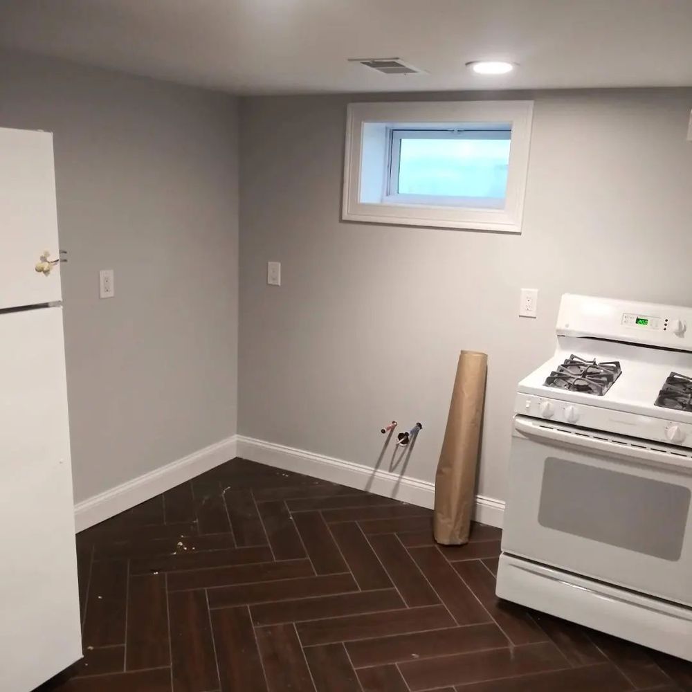 A kitchen with a stove and a refrigerator in it