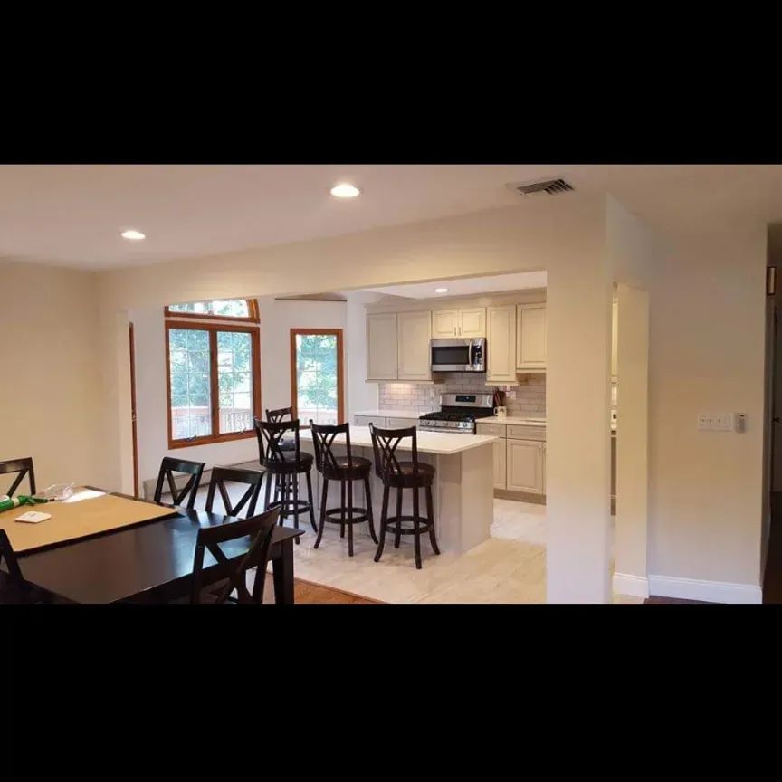 A kitchen with a table and chairs in it