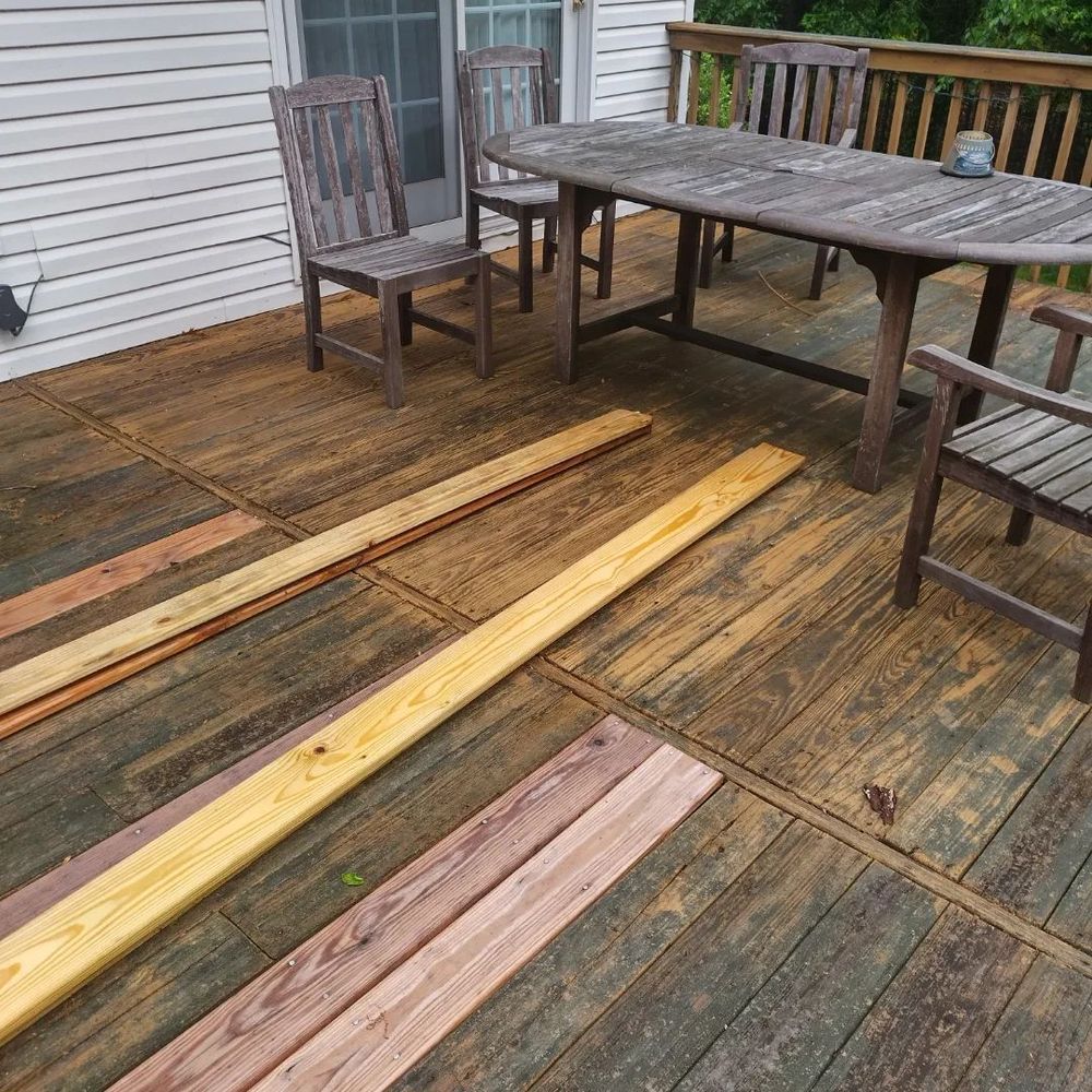 A wooden deck with a table and chairs on it