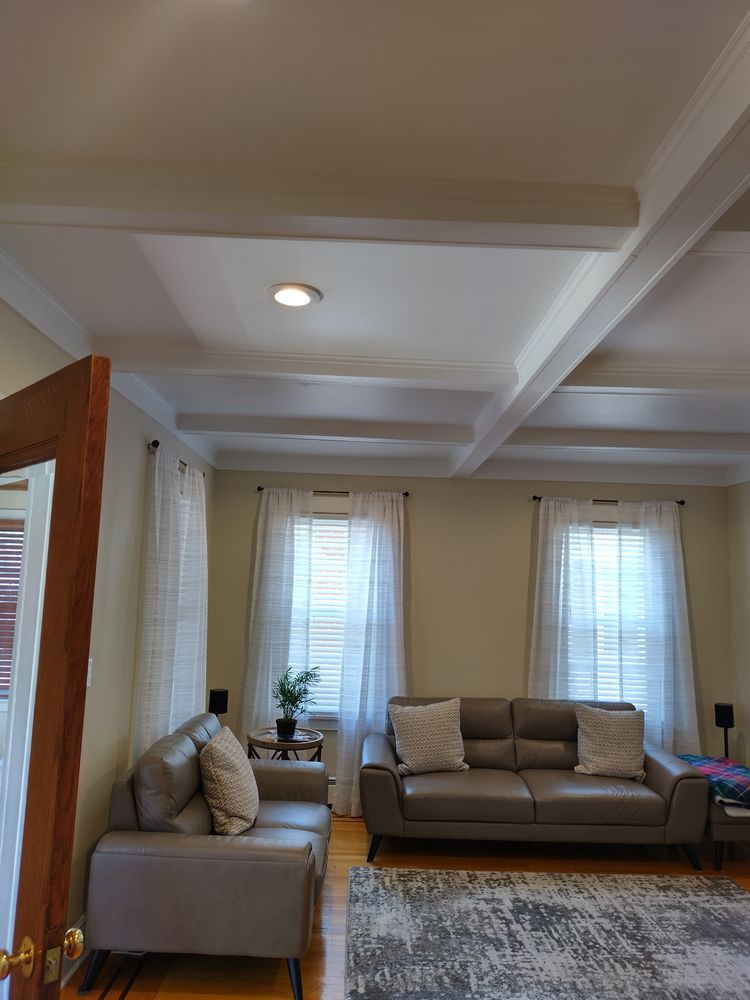 A living room with a couch, chair, and rug