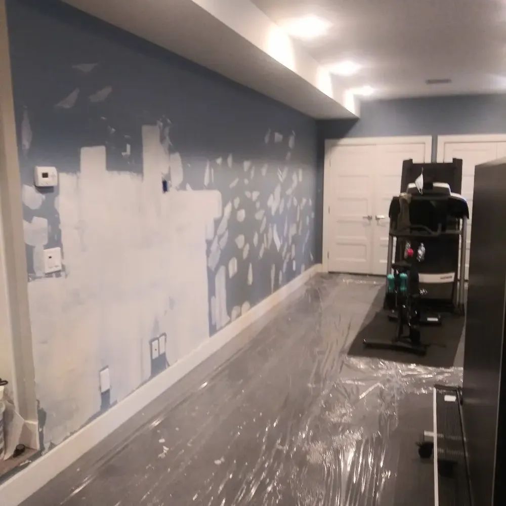 A room with a painting on the wall that says ' a ' on it