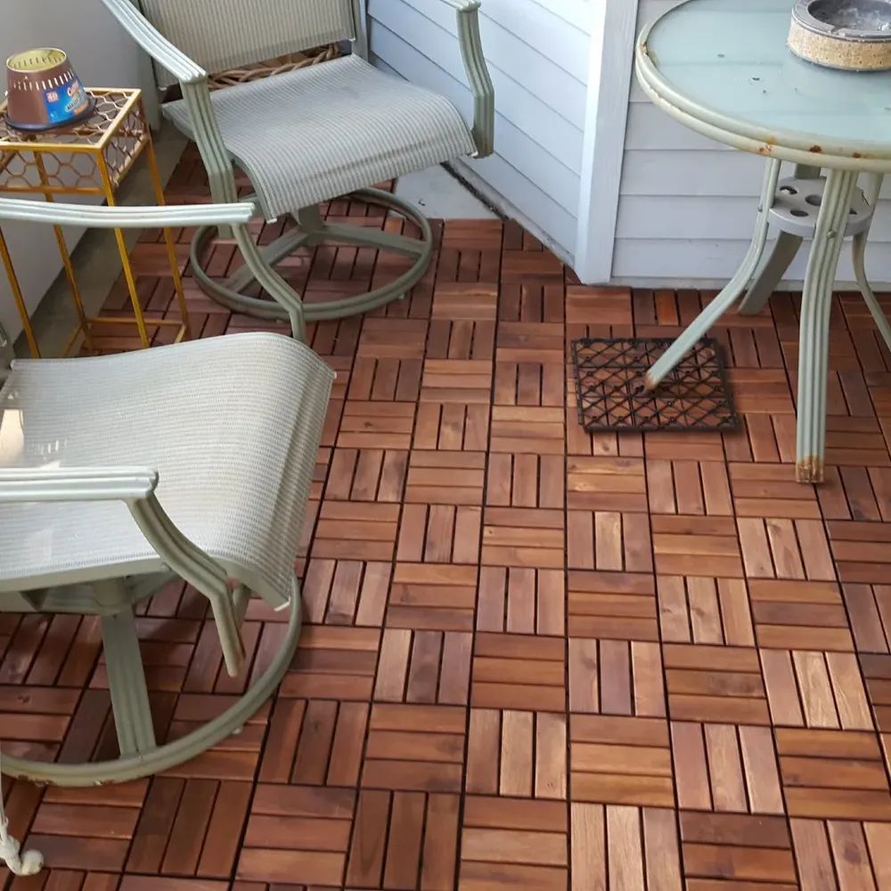 A wooden floor with a table and chairs on it