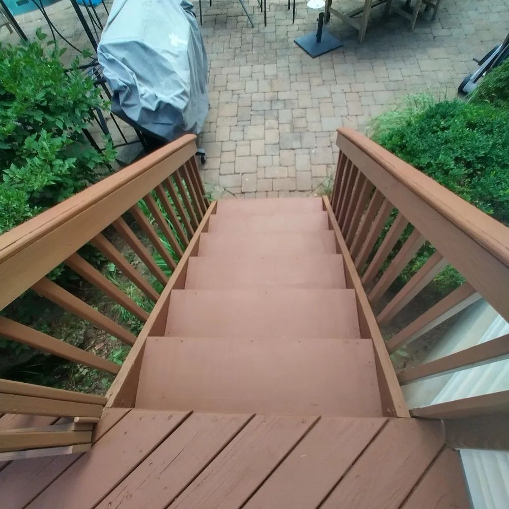 A set of wooden stairs leading up to a patio